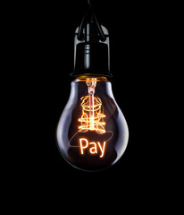 Hanging lightbulb with glowing Pay concept.