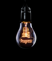 Hanging lightbulb with glowing Progress concept.