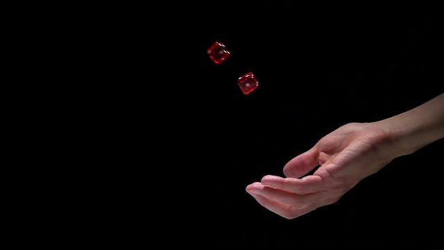 Hand throwing dice in slow motion with frozen moment. Concept film clip of chance, risk and stopped time.