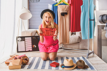 Happy girl presenting fashionable things for blog