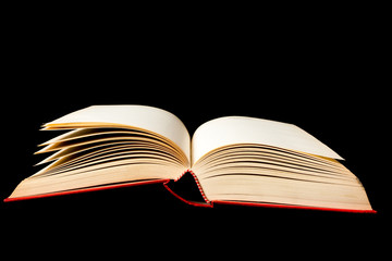 Vintage old open book on black background