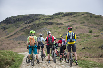 Mountain bikers stop to consider their route around Loughrigg Fell in the Lake District National Park, Cumbria