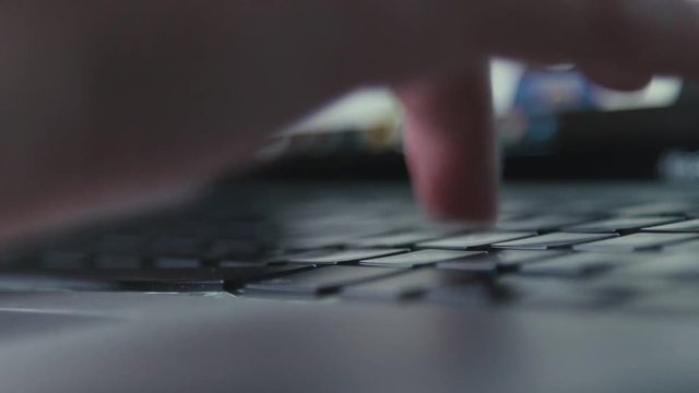 Extra close up of quckly typing work on computer. Typing text on a laptop computer keyboard. Black keyboard key. Networking. Typing message or email on laptop, searching in Internet