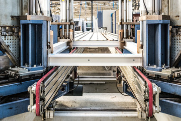 Manual worker assembling glass panels for PVC windows. Manufacturing jobs.Factory for aluminum and PVC windows and doors production. Tempered float glass panels