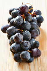 Bunch of red wine grapes on wooden table