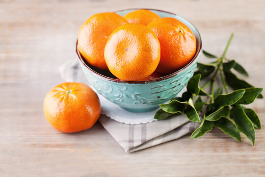 Mandarin Fruits in the Bowl on Vintage Wooden Background