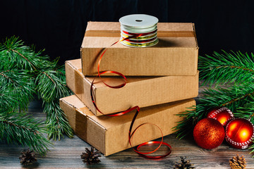 A girl holding a box over the table. Parcel delivery. Christmas background.