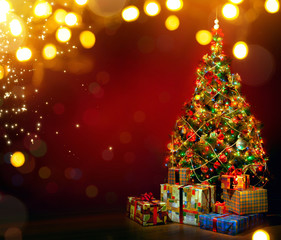Beautiful decorated Christmas tree with present boxes and magic