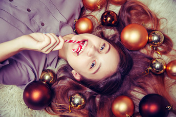 Fototapeta na wymiar Beautiful girl with a Christmas candy.
