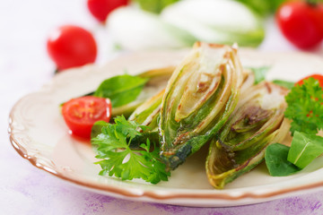Baked chicory with onions and herbs.