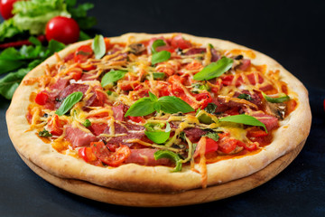 Pizza with salami, ham, tomato, cheese and mushrooms