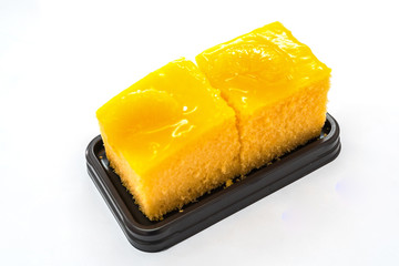 Triple orange cake sliced on white background for copy space
