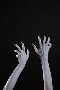 Pale ghost hands with sharp black nails, body art