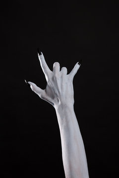 Pale monster hand showing heavy metal symbol