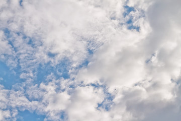 White fluffy clouds float in the blue sky