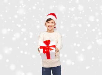 smiling happy boy in santa hat with gift box