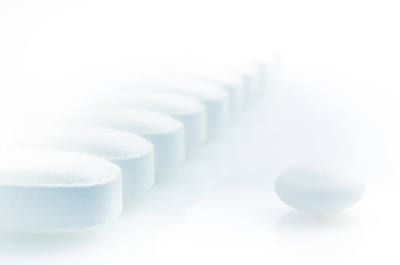 Closeup. Pharmacy theme. White Pills on the White Background