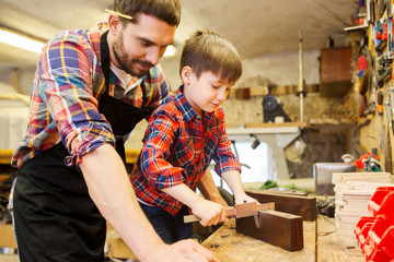 boy and dad with calipers measure wood at workshop