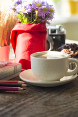 sunny morning breakfast table with a cup of coffee, bouquet of blue flowers muffins and old camera. place for lovely messages. soft focus image 