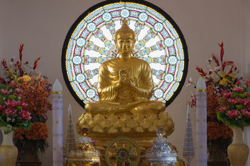 Buddha statue and Wheel of life background made from mosaic