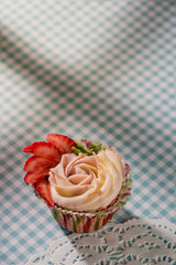 Cupcake with strawberry on a light background