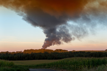 Obraz na płótnie Canvas Smoke of a fire at sunset