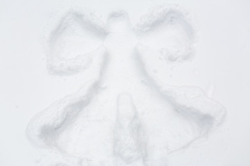 angel silhouette or print on snow surface