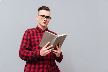 From below image of man in glasses with book