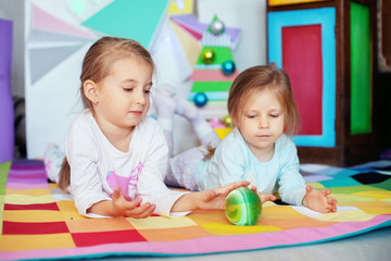Fototapeta premium Two young sisters in their pajamas. Christmas concept 