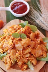 Fried macaroni with sausage and tomato sauce.