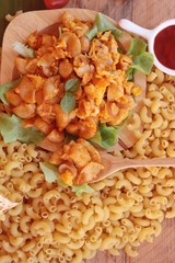 Fried macaroni with sausage and tomato sauce.