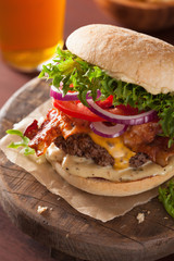 bacon cheese burger with beef patty tomato onion beer