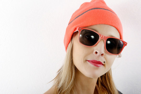 beautiful blond woman with winter hat and sunglasses