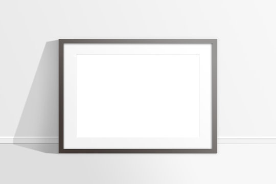 Blank photo frame against the wall, mock up. 