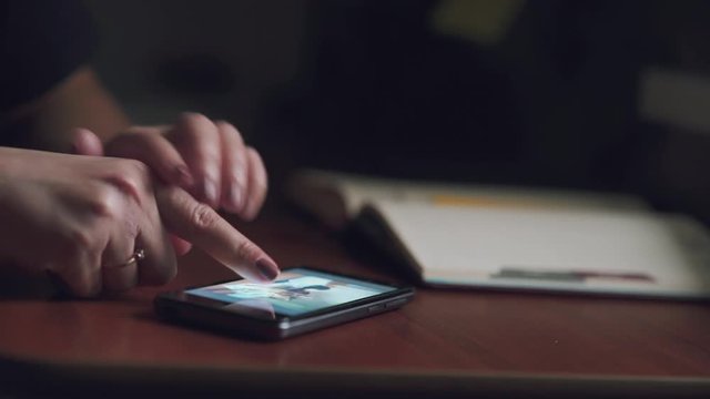 Closeup image on a female hands holding smartphone