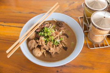 Beef noodle soup on wooden table