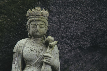 Fototapeta na wymiar stone carving buddha statue sculpture in Japanese style at Japan
