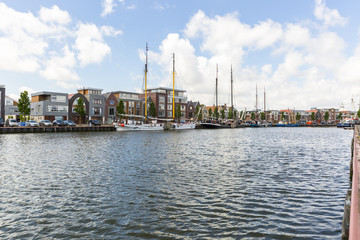 Obraz premium Noorderhaven canal with boats and houses in historic old town of Harlingen, Friesland, Netherlands