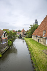 Fototapeta na wymiar view on Dutch village with a canal, The Netherlands