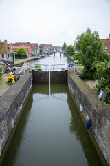 view on Dutch village with a canal and a lock , The Netherlan
