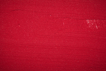 Fototapeta premium Close up plane background texture of solid red color made of soil.