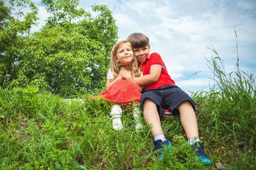 little boy and girl outdoor in park