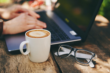 Business woman working at laptop outside. Concept of connection and mobility. 
