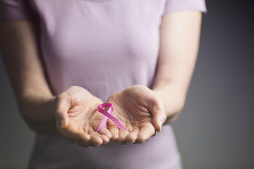 Woman Holding a Pink Ribbon