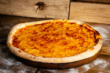 Cheese pizza wood background