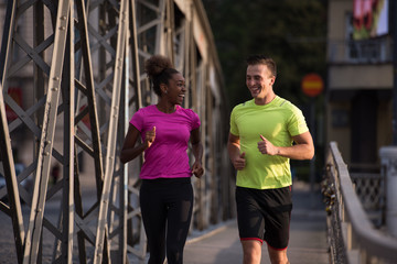 multiethnic couple jogging in the city