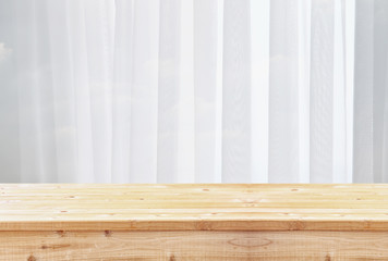 image of wooden table in front of blurred window light