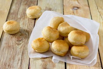 Doughnuts with filling sweet cottage cheese on a wooden backgrou