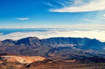 Naklejka na ściany i meble Beautiful aerial view of volcano caldera from summit Pico del Teide mountain. Lava rocks and volcanic Mars landscape in El Teide National park. Main landmark on Tenerife, Canary Islands, Spain.