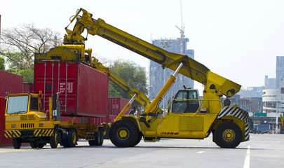Fototapeta premium forklift handling container box loading to freight train